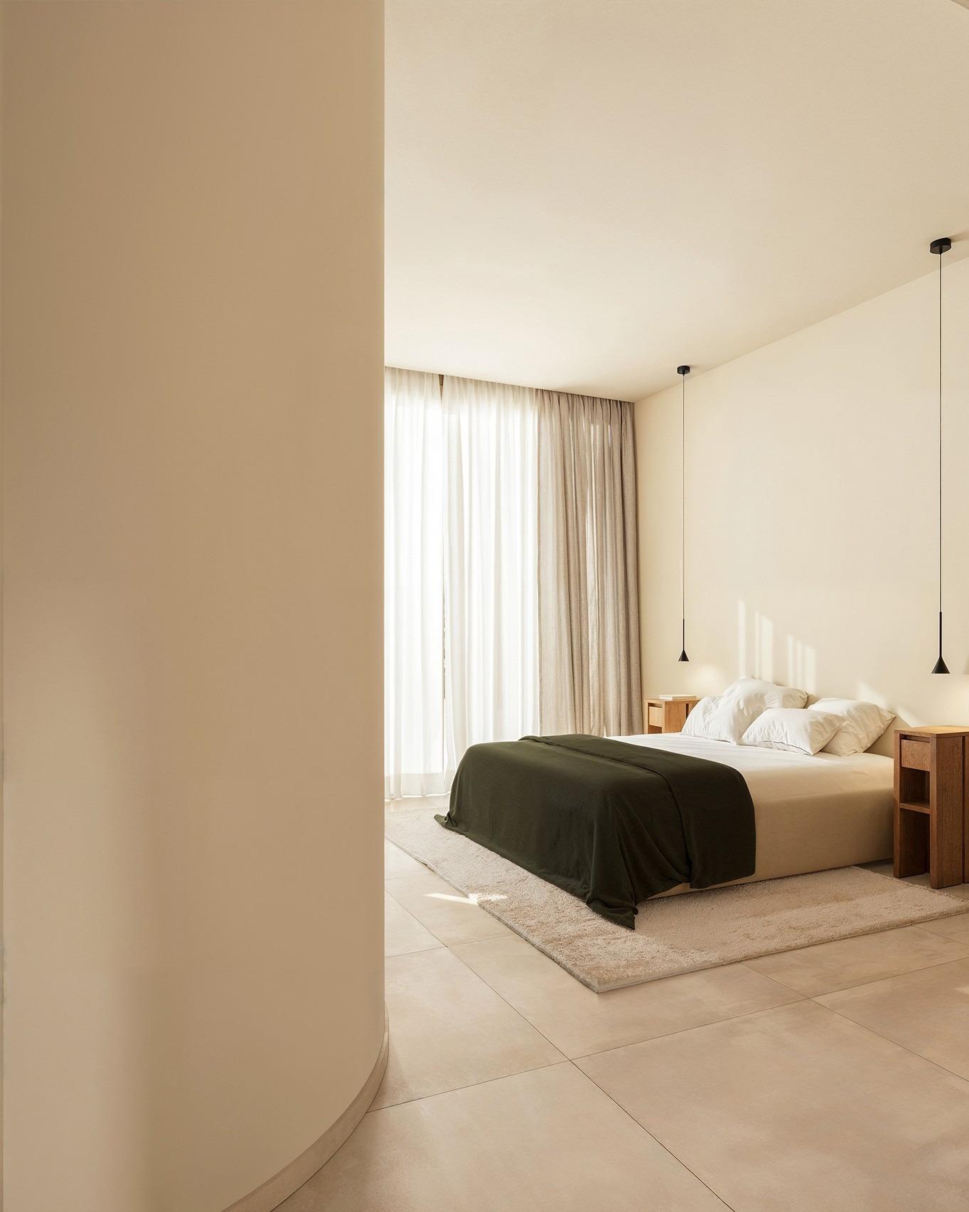 Sun-drenched minimalist bedroom with elegant neutral tones in exclusive Ibiza style villa on La Finca Golf, Algorfa, Costa Blanca.