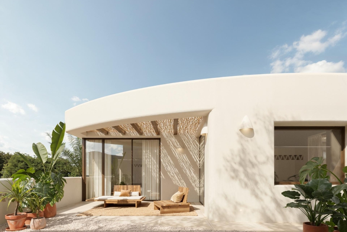 Sun-drenched terrace with elegant seating and lush plants at the exclusive 4-bedroom Ibiza style villa in Algorfa, Costa Blanca.