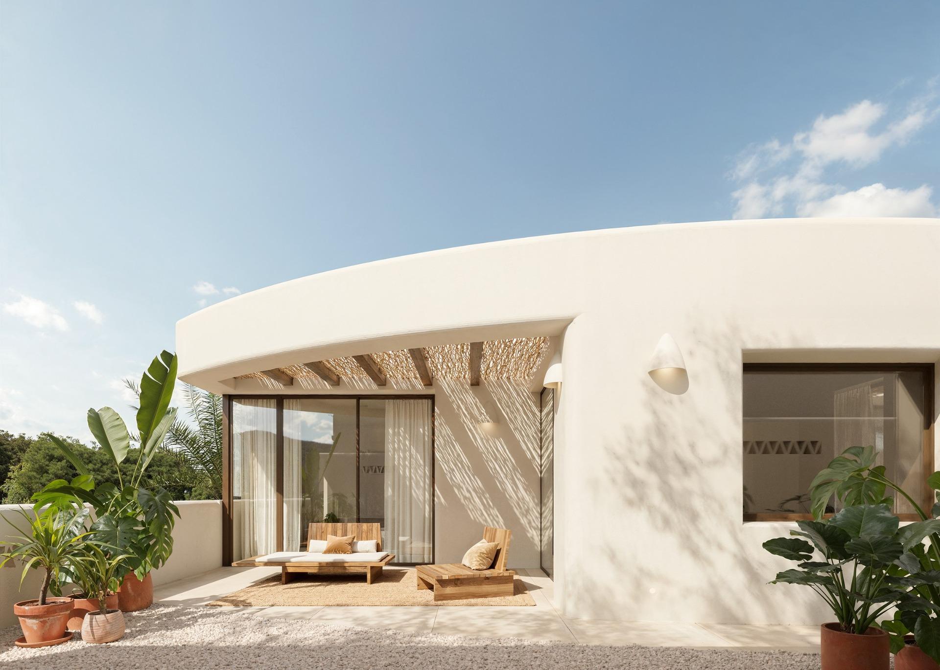 Sun-drenched terrace with elegant seating and lush plants at the exclusive 4-bedroom Ibiza style villa in Algorfa, Costa Blanca.
