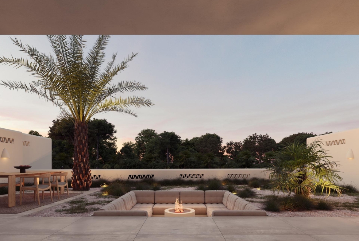 Sun-drenched outdoor lounge with firepit, palm trees, and elegant dining area at Ibiza style villa on La Finca Golf, Costa Blanca.