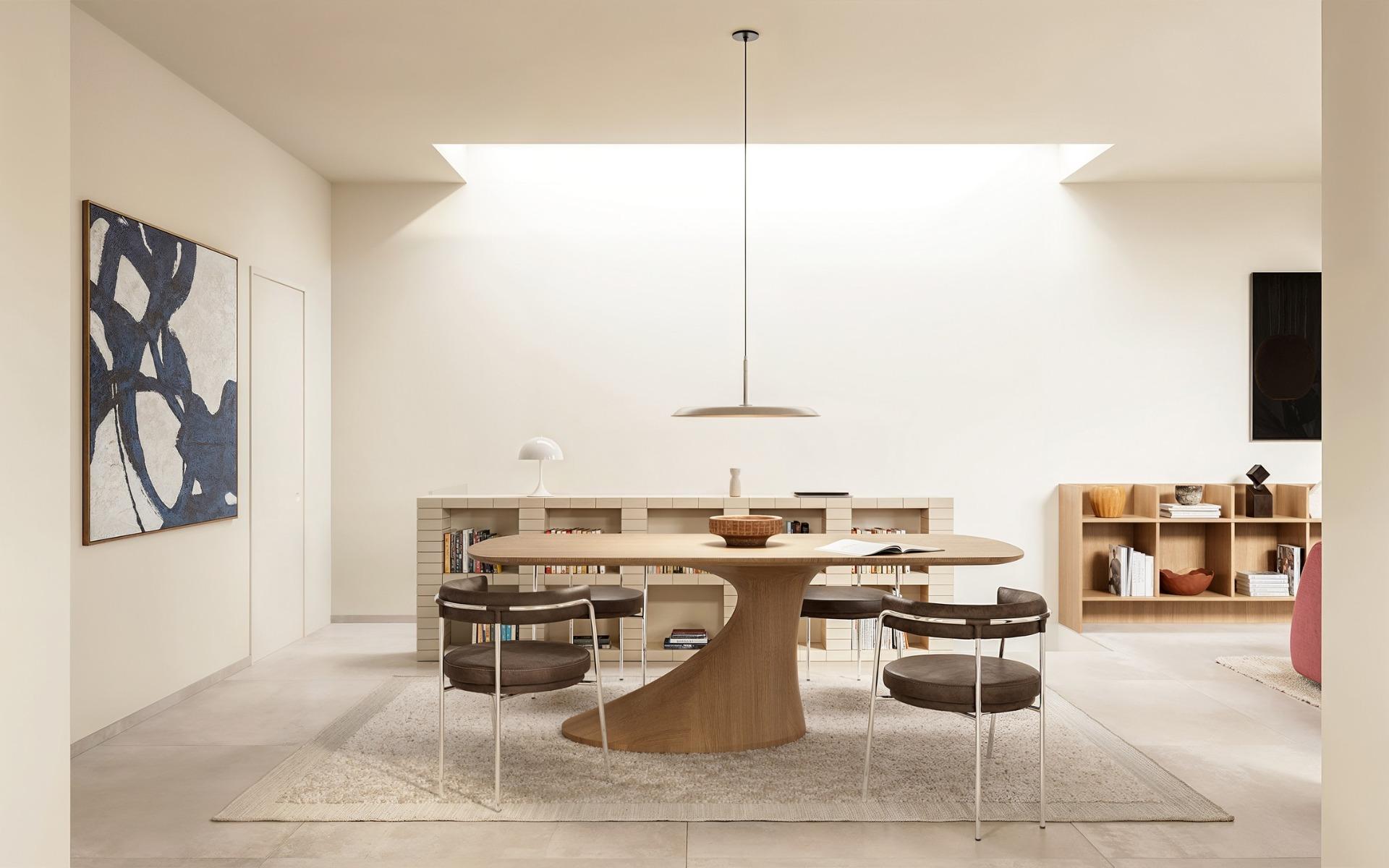 Bright and airy dining area with minimalist wooden table in exclusive Ibiza style 4-bedroom villa in Algorfa, Costa Blanca.