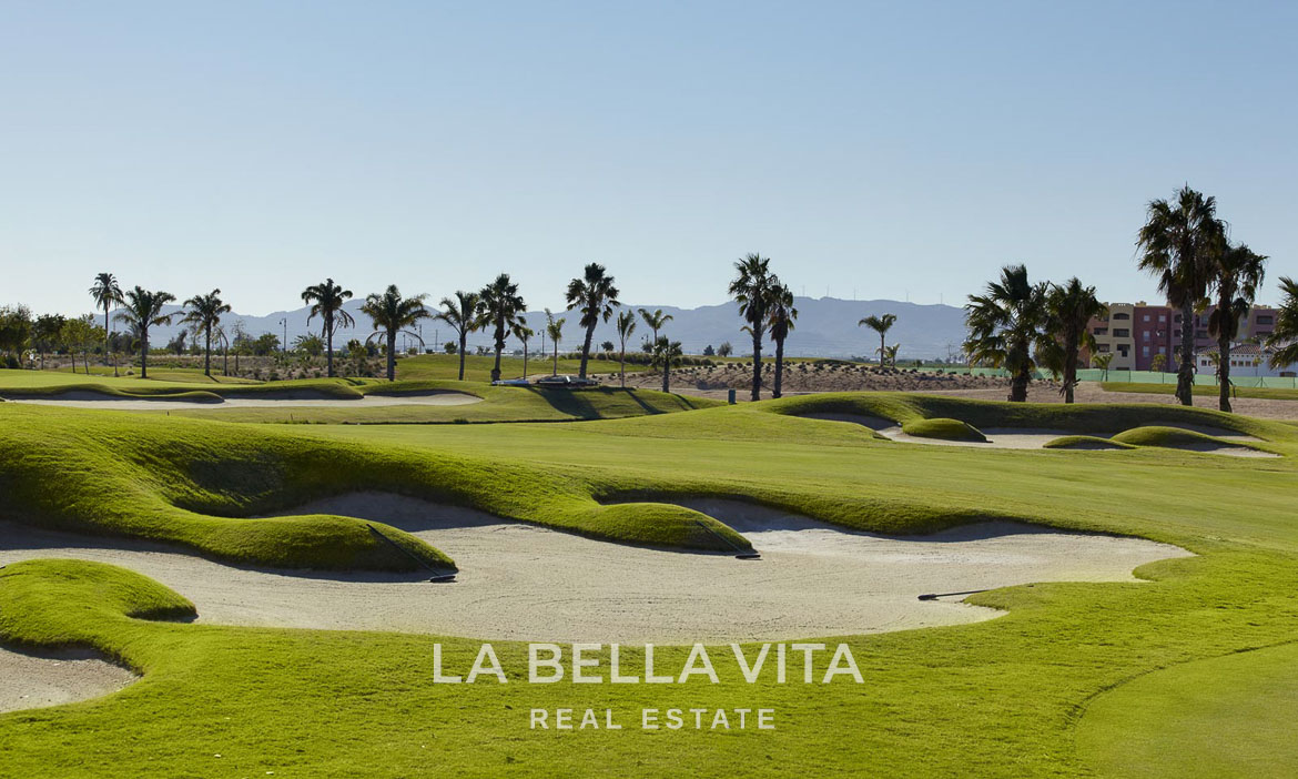 Sunlit golf course with manicured greens and palm trees at Hacienda del Álamo Golf Resort, Murcia luxury villa location