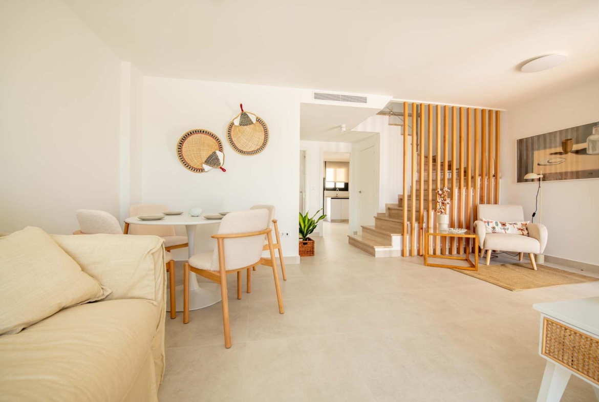 Bright, modern open-plan living and dining area in a top floor 3-bedroom bungalow with stylish wooden accents in Cox, Alicante.