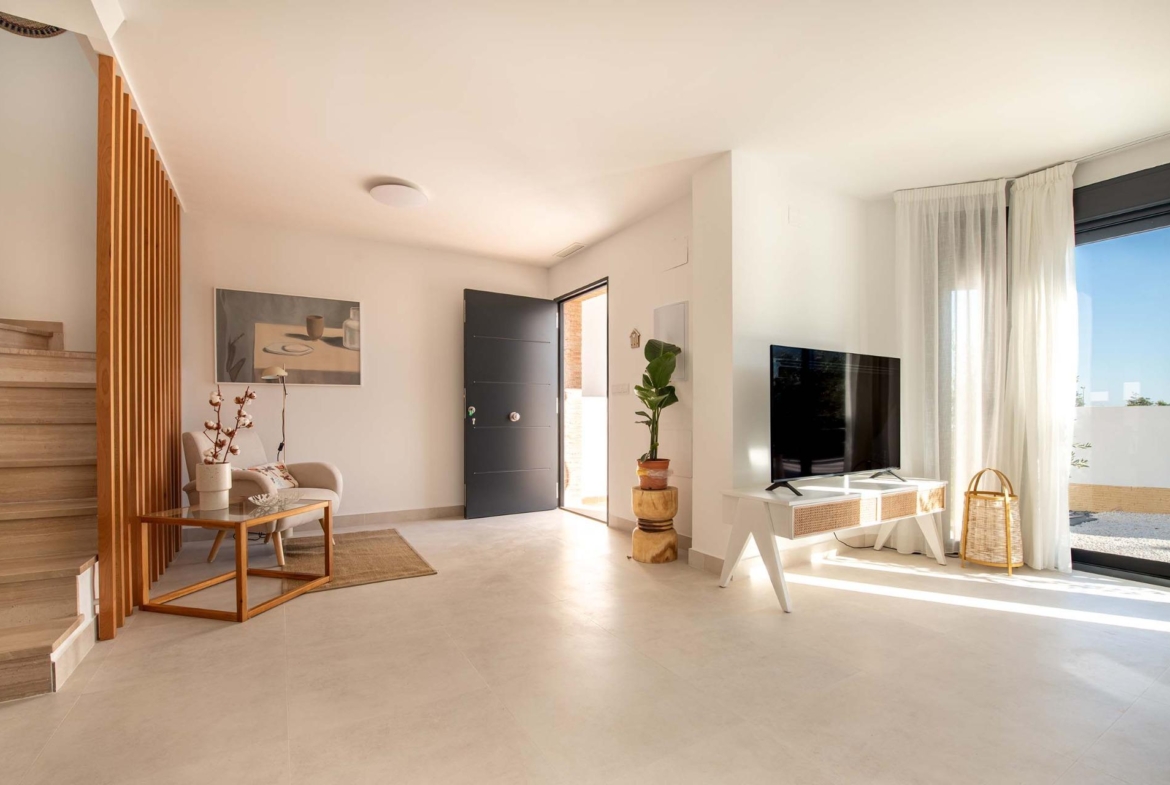 Bright, modern living area in a 2-bedroom top floor bungalow with sunlit open layout and terrace access in Cox, Alicante.