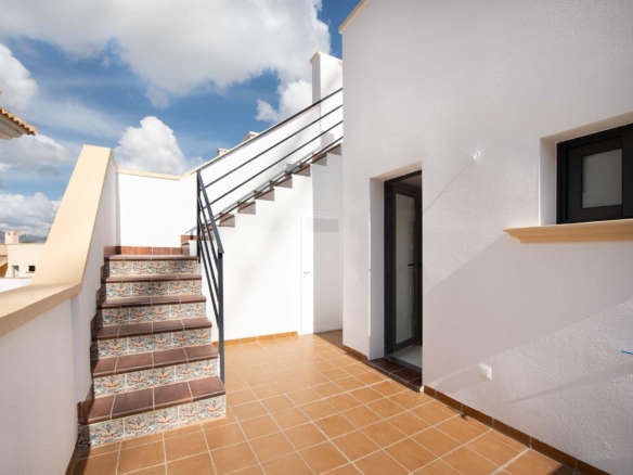 Spacious sunlit top floor terrace with decorative tiled stairs in a modern 3-bedroom bungalow in Cox, Alicante.