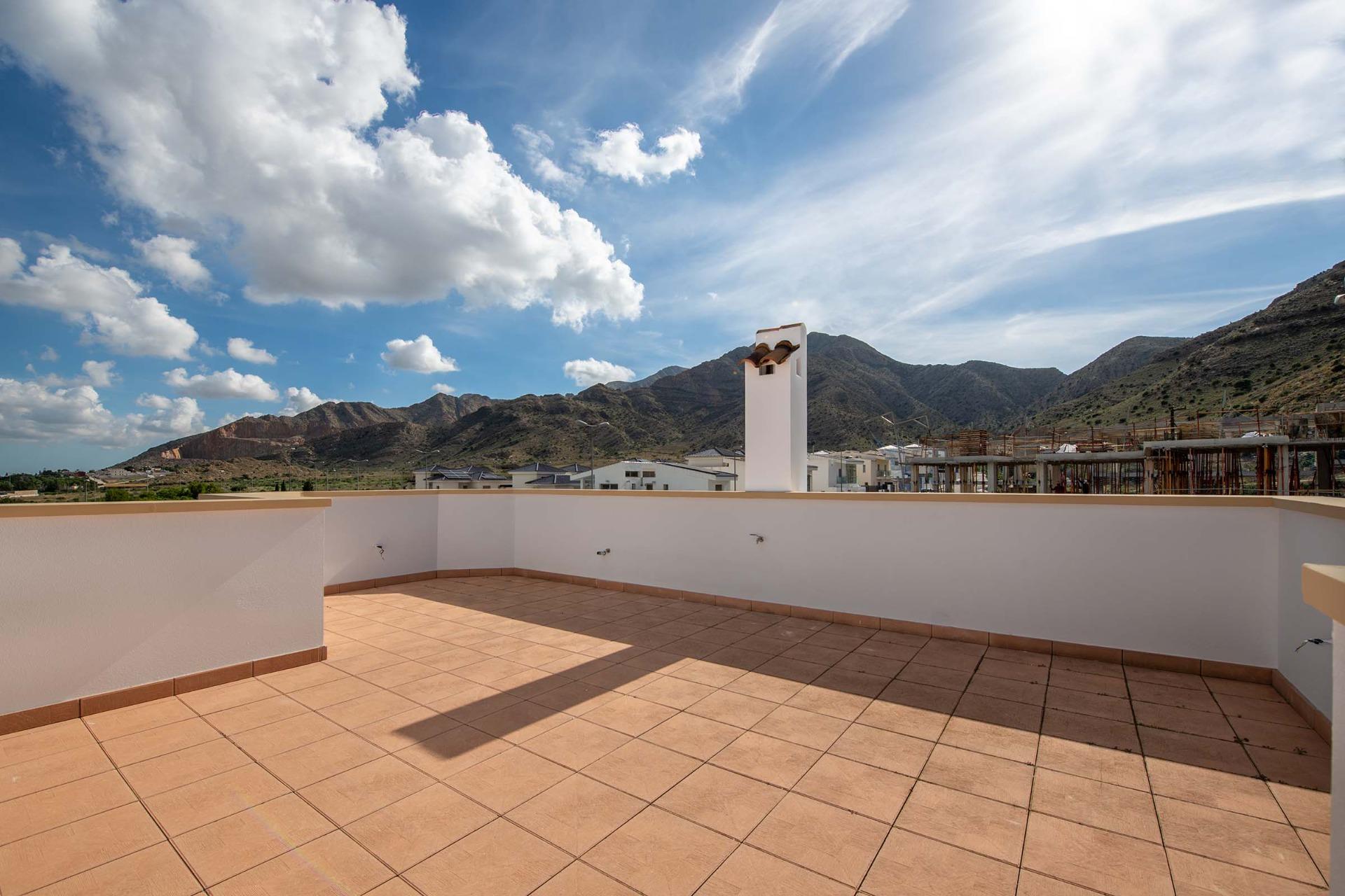 Spacious sun-drenched solarium with panoramic mountain views in modern 3-bedroom townhouse for sale in Cox, Alicante.