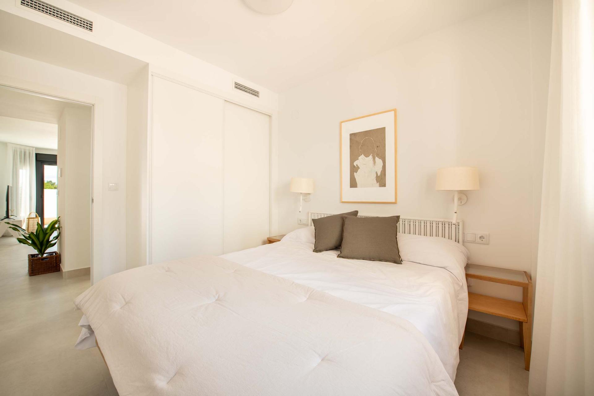 Bright, airy bedroom with modern decor in a key ready 3-bedroom top floor bungalow in Cox, Alicante.