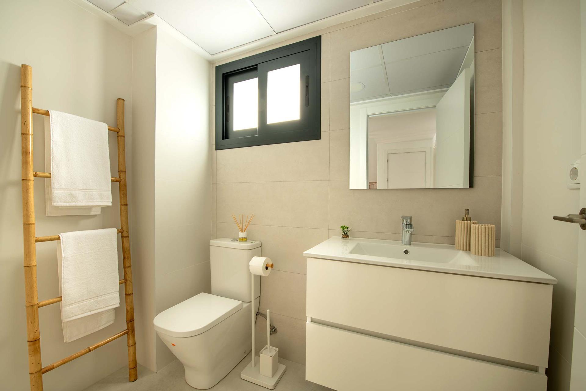 Bright modern bathroom with sleek fixtures and natural light in a luxury 3-bedroom top floor bungalow in Cox, Alicante.