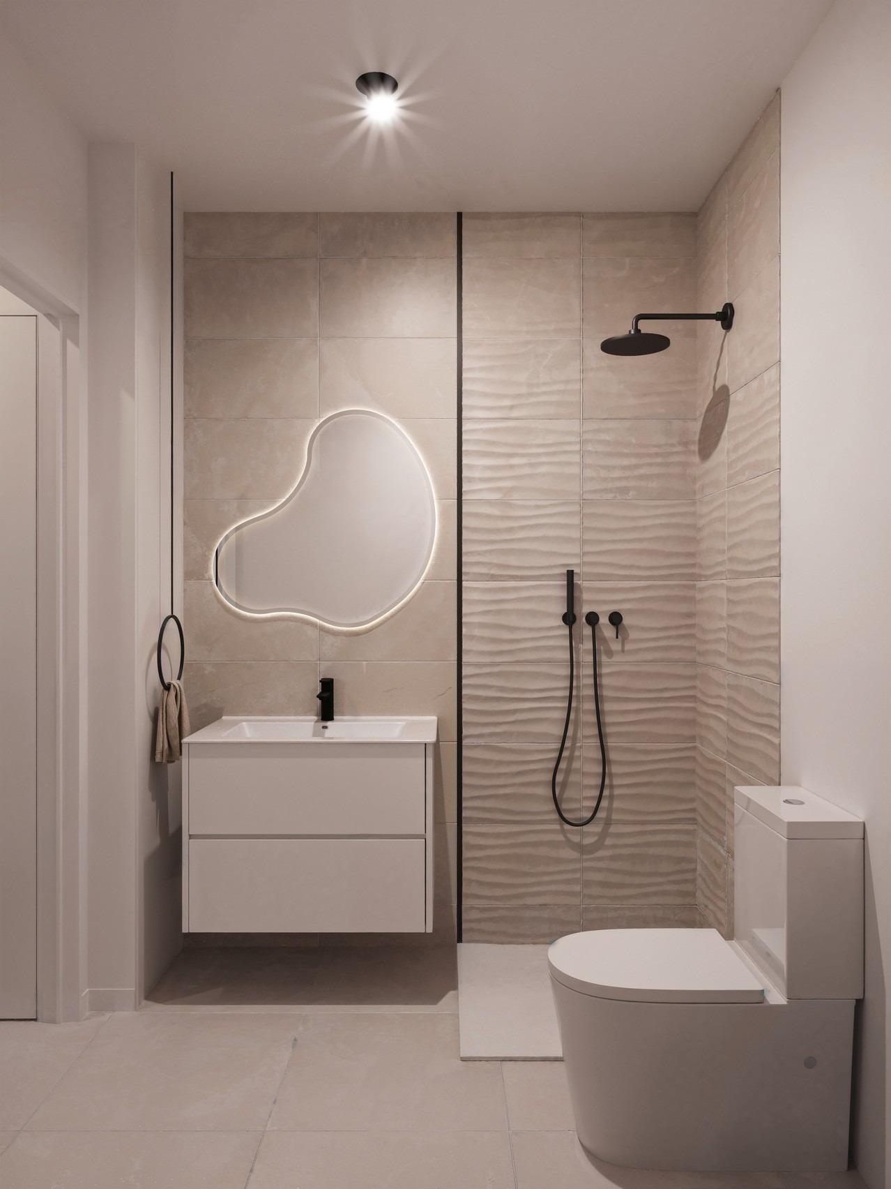 Elegant modern bathroom with sculptural backlit mirror and sleek walk-in shower in 3-bedroom ground floor apartment, San Miguel de Salinas