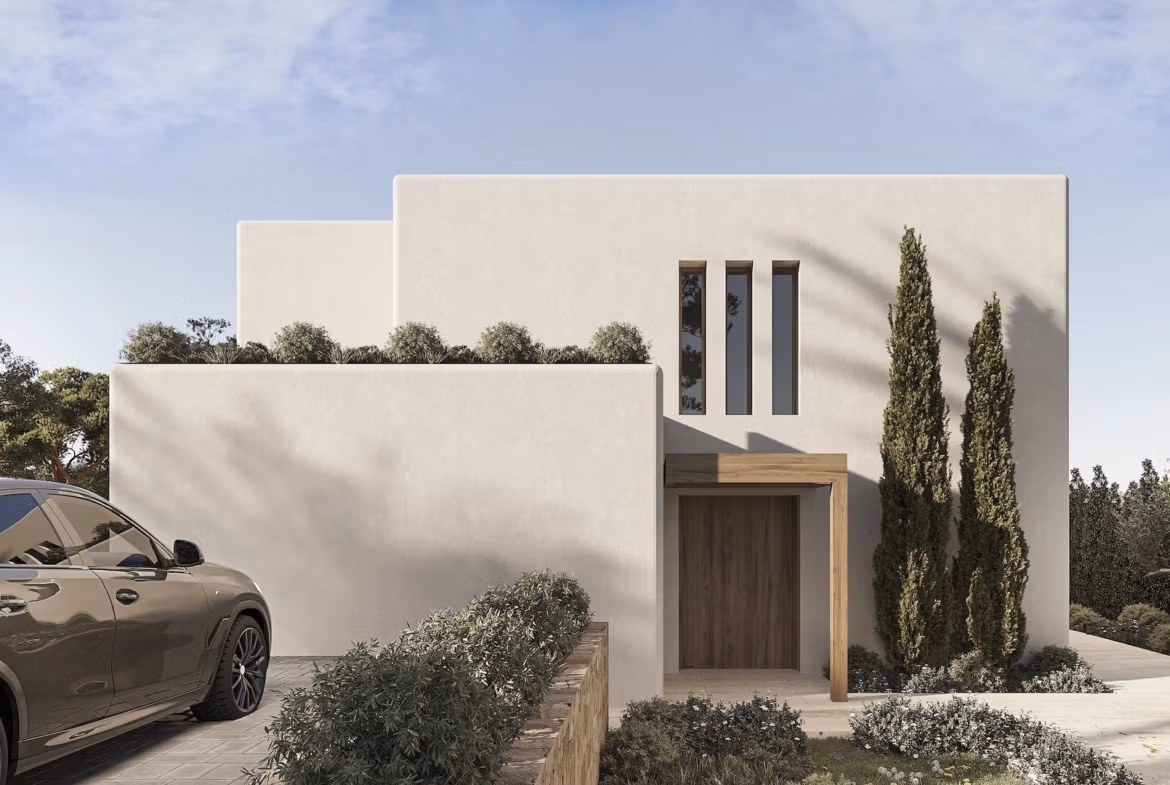 Modern luxury Ibizan villa facade with clean lines, lush landscaping, and private driveway in La Fustera, Benissa