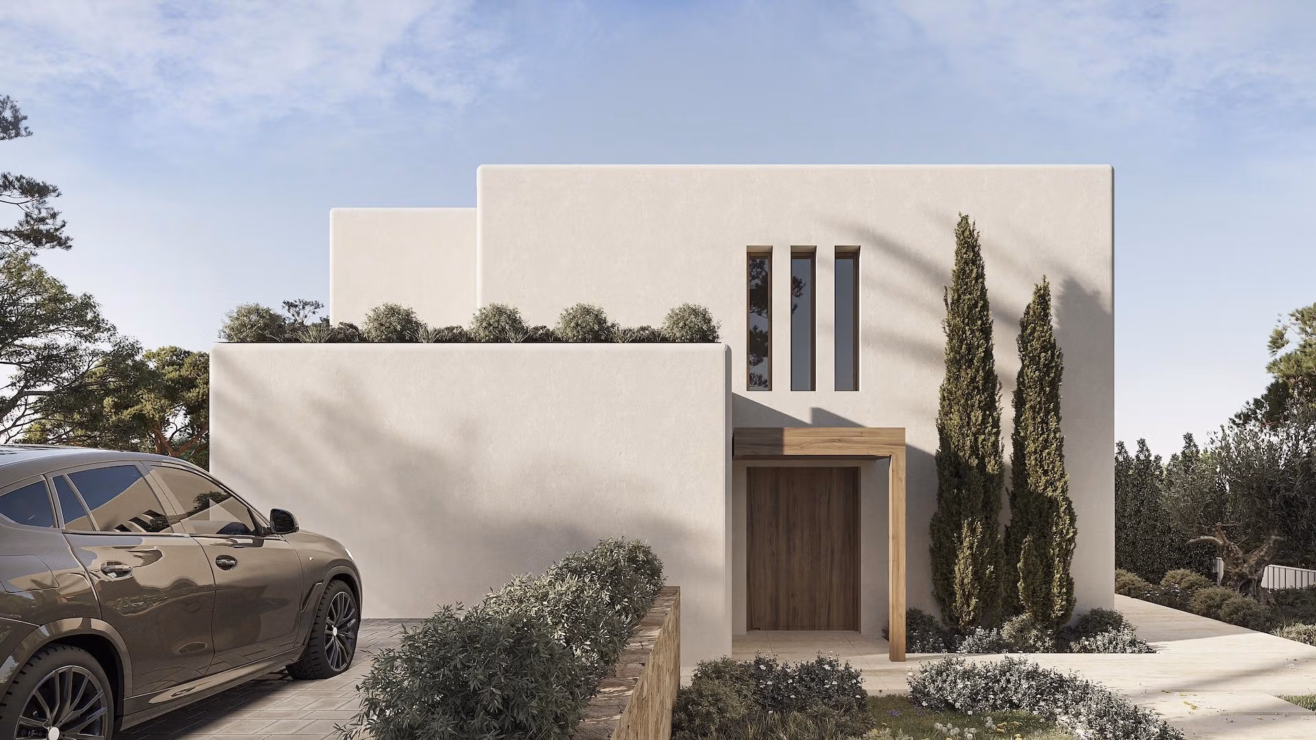 Modern luxury Ibizan villa facade with clean lines, lush landscaping, and private driveway in La Fustera, Benissa