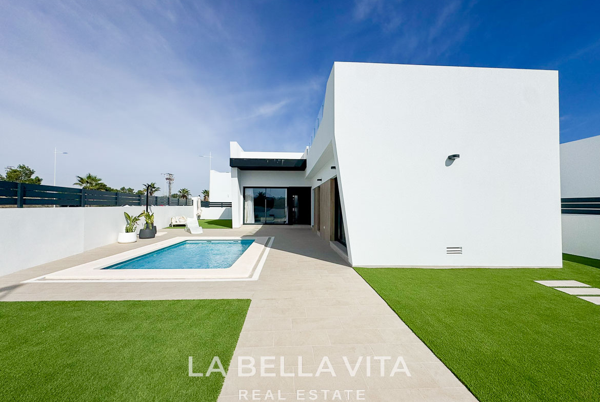 Sleek modern 3-bedroom villa in San Miguel de Salinas with private pool, minimalist exterior, and sunlit terrace area.