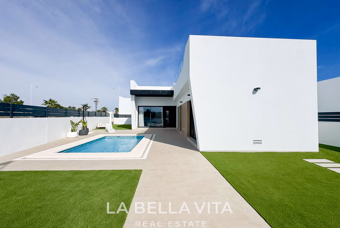 Sleek modern 3-bedroom villa in San Miguel de Salinas with private pool, minimalist exterior, and sunlit terrace area.