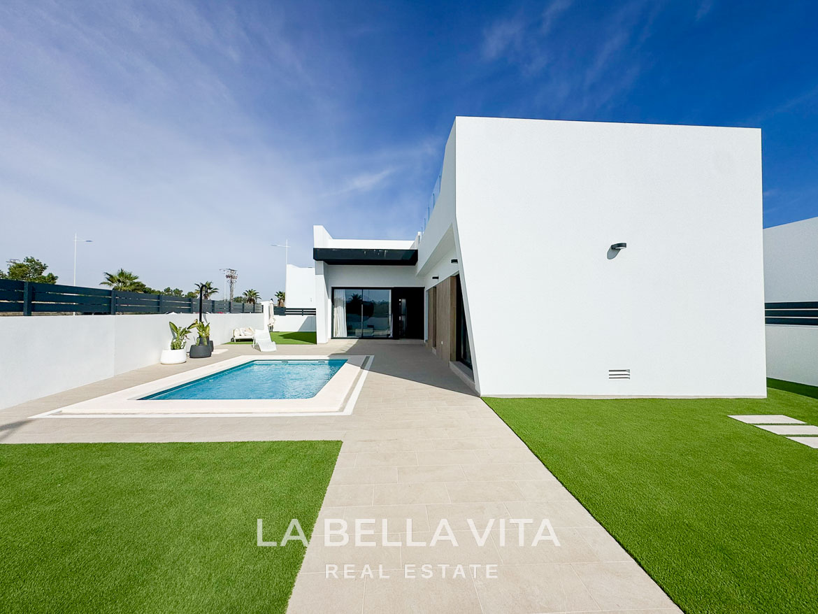 Sleek modern 3-bedroom villa in San Miguel de Salinas with private pool, minimalist exterior, and sunlit terrace area.