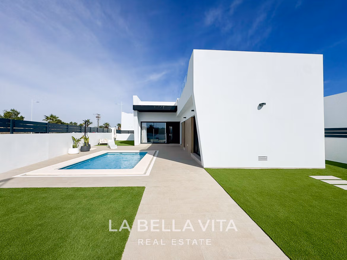 Sleek modern 3-bedroom villa in San Miguel de Salinas with private pool, minimalist exterior, and sunlit terrace area.