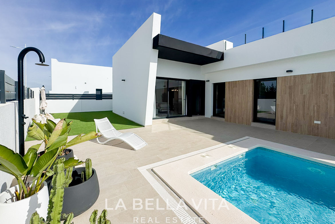 Sun-drenched modern 3-bedroom villa exterior with private pool and terrace in San Miguel de Salinas, showcasing sleek architectural lines.