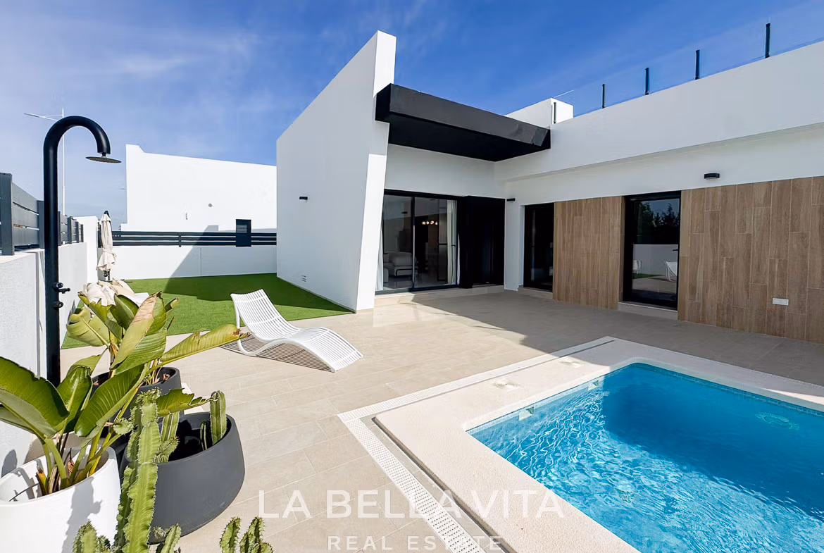Sun-drenched modern 3-bedroom villa exterior with private pool and terrace in San Miguel de Salinas, showcasing sleek architectural lines.