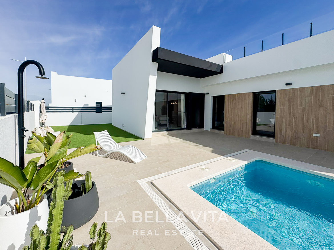 Sun-drenched modern 3-bedroom villa exterior with private pool and terrace in San Miguel de Salinas, showcasing sleek architectural lines.
