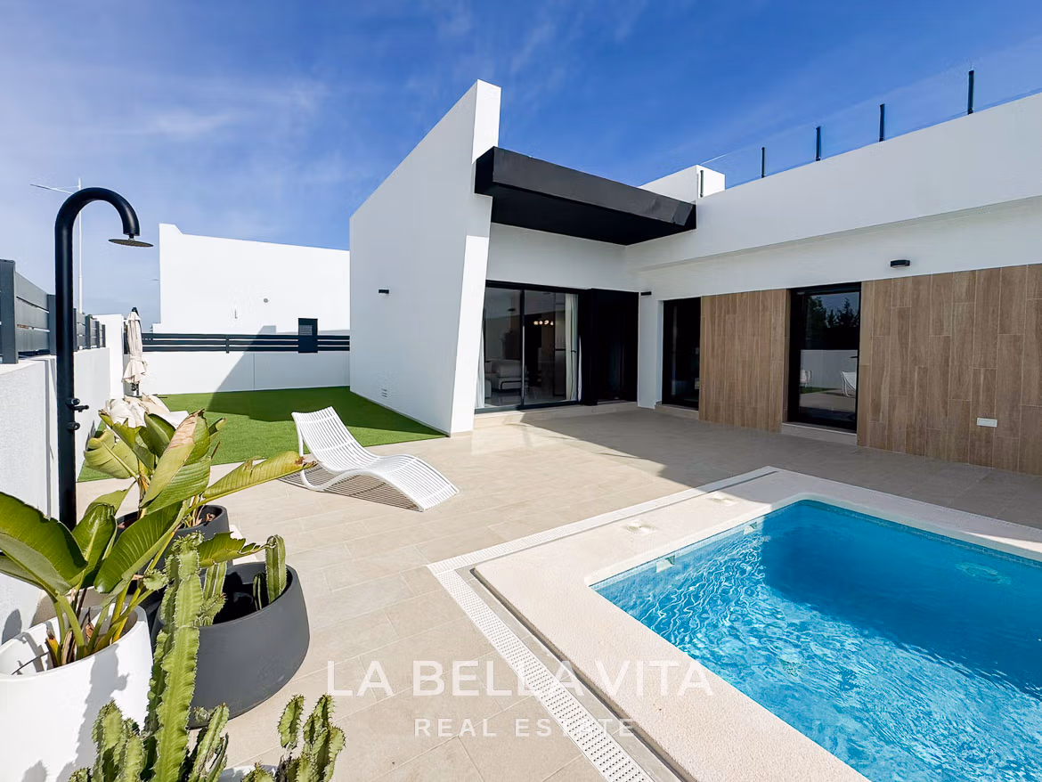 Sun-drenched modern 3-bedroom villa exterior with private pool and terrace in San Miguel de Salinas, showcasing sleek architectural lines.
