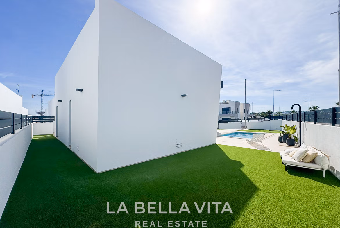 Bright modern 3-bedroom villa exterior with private pool, sun-drenched terrace, and landscaped lawn in San Miguel de Salinas
