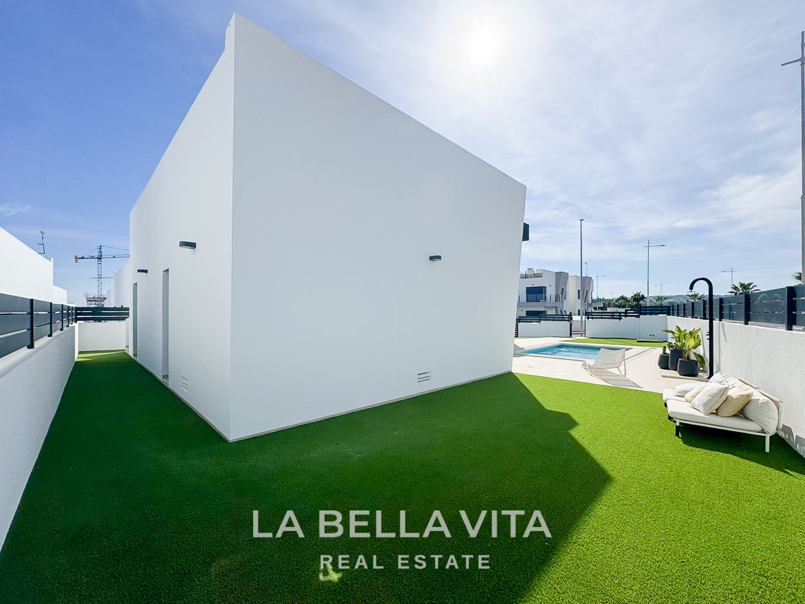 Bright modern 3-bedroom villa exterior with private pool, sun-drenched terrace, and landscaped lawn in San Miguel de Salinas