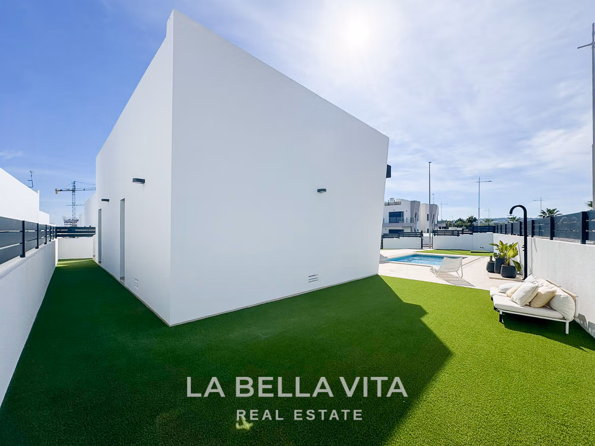 Bright modern 3-bedroom villa exterior with private pool, sun-drenched terrace, and landscaped lawn in San Miguel de Salinas