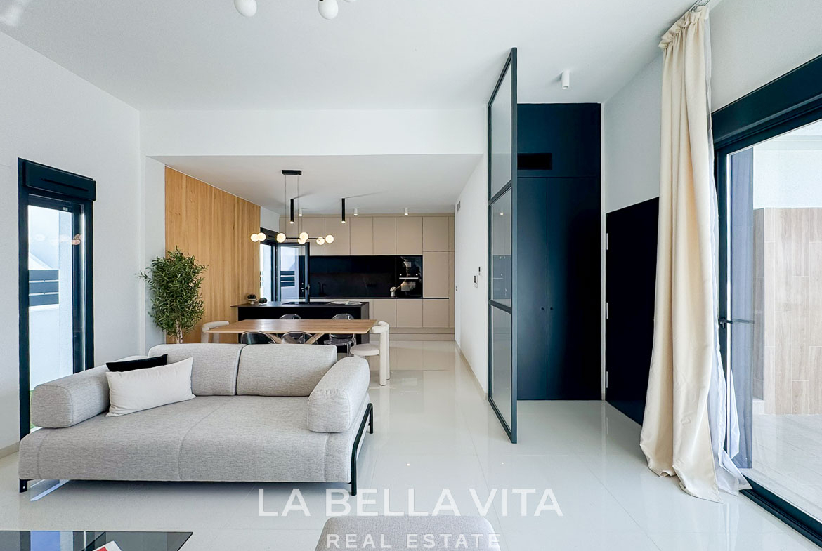 Bright, modern open-plan living and kitchen area in a luxury 3-bedroom villa in San Miguel de Salinas, with sleek design and natural light.