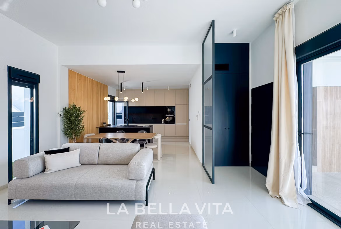 Bright, modern open-plan living and kitchen area in a luxury 3-bedroom villa in San Miguel de Salinas, with sleek design and natural light.