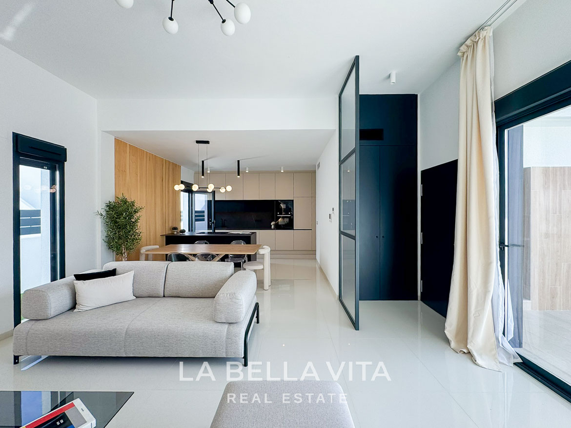 Bright, modern open-plan living and kitchen area in a luxury 3-bedroom villa in San Miguel de Salinas, with sleek design and natural light.