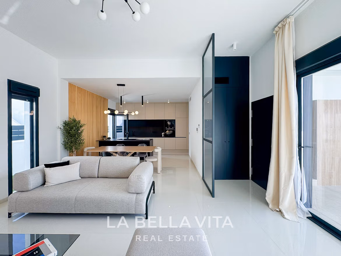 Bright, modern open-plan living and kitchen area in a luxury 3-bedroom villa in San Miguel de Salinas, with sleek design and natural light.