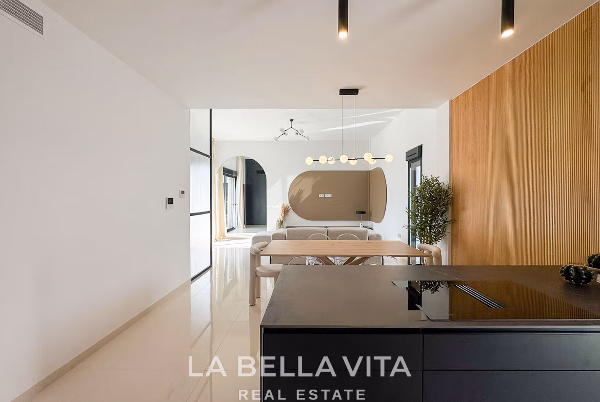 Bright, modern open-plan kitchen and dining area in a sleek 3-bedroom villa with elegant design in San Miguel de Salinas