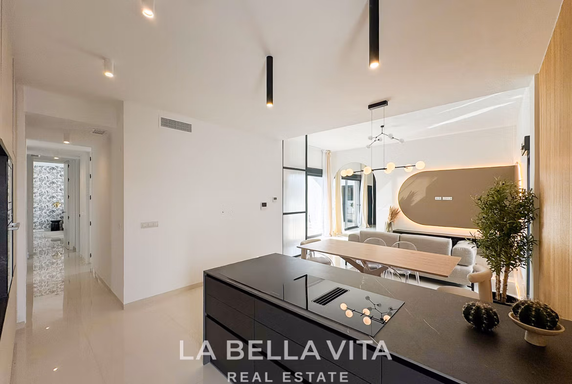 Bright modern open-plan kitchen and dining area in a stylish 3-bedroom villa in San Miguel de Salinas.