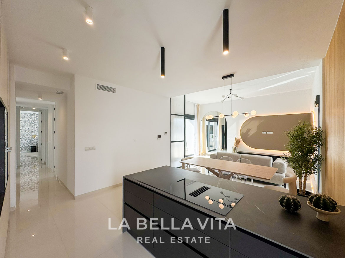 Bright modern open-plan kitchen and dining area in a stylish 3-bedroom villa in San Miguel de Salinas.