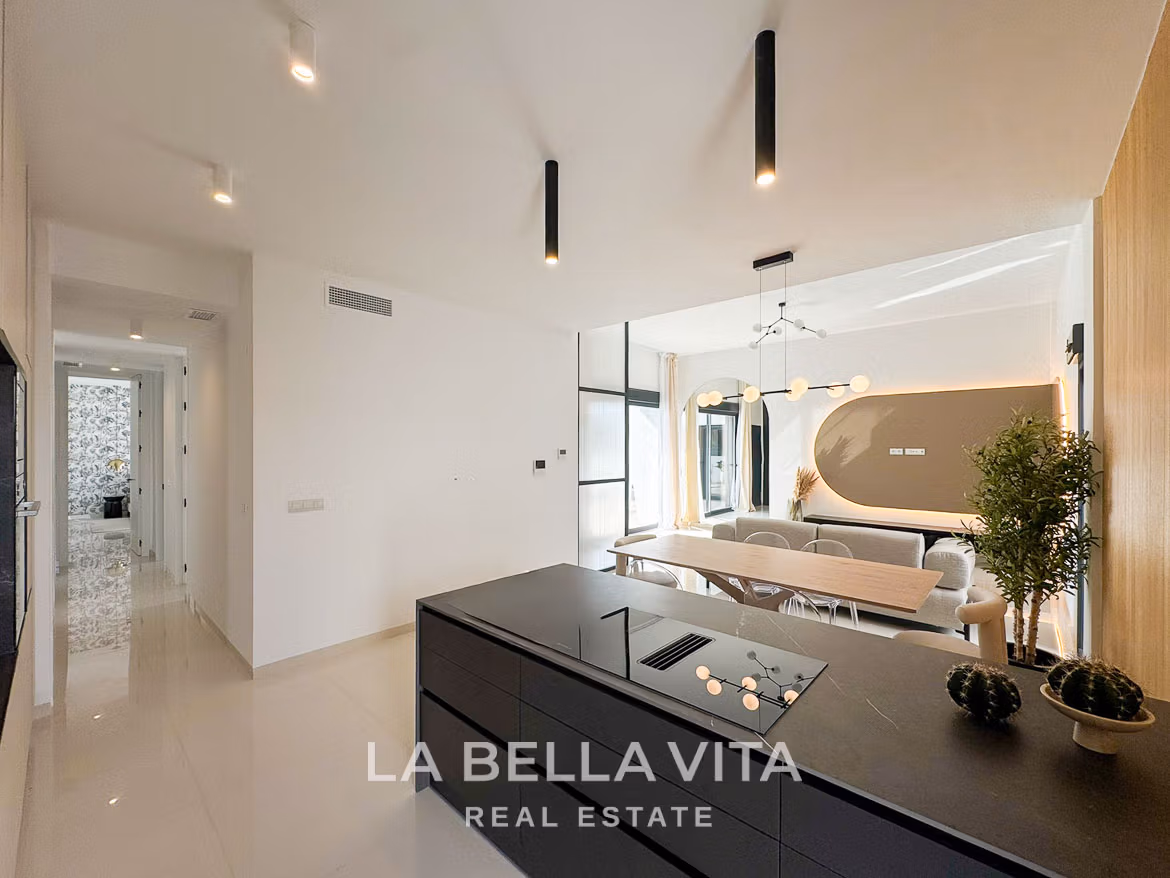 Bright modern open-plan kitchen and dining area in a stylish 3-bedroom villa in San Miguel de Salinas.