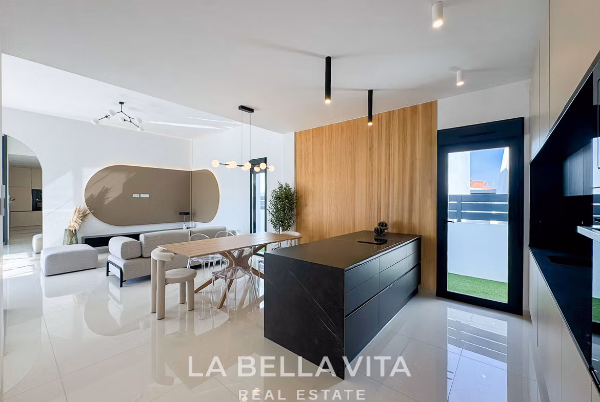 Bright modern open-plan kitchen and living area in a 3-bedroom villa with sleek design in San Miguel de Salinas.