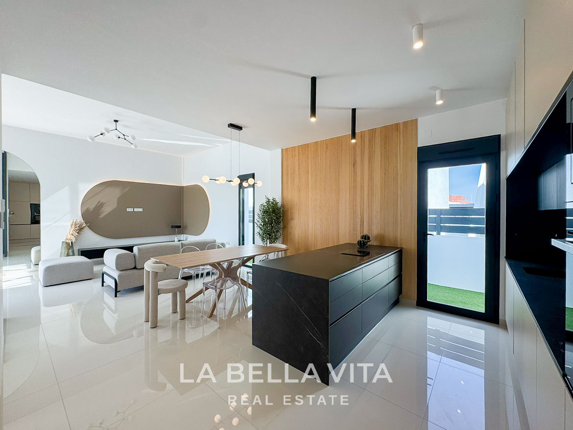 Bright modern open-plan kitchen and living area in a 3-bedroom villa with sleek design in San Miguel de Salinas.