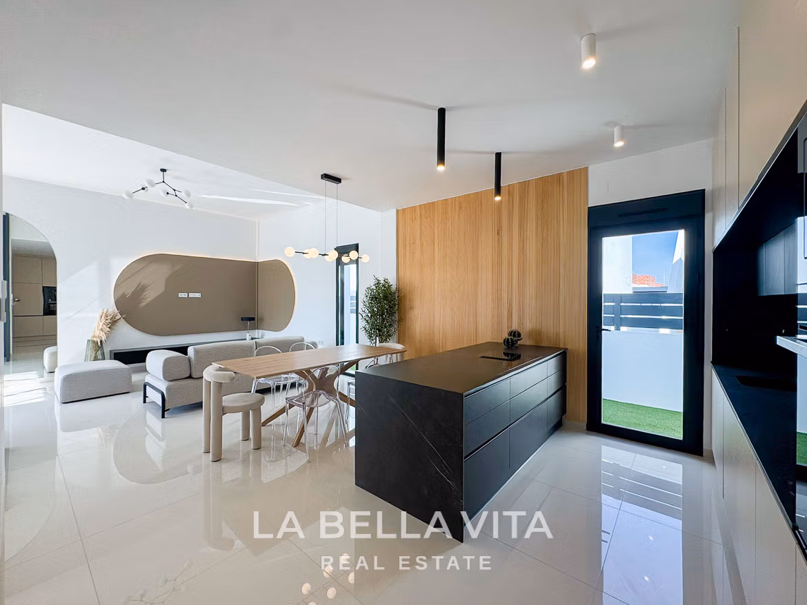 Bright modern open-plan kitchen and living area in a 3-bedroom villa with sleek design in San Miguel de Salinas.