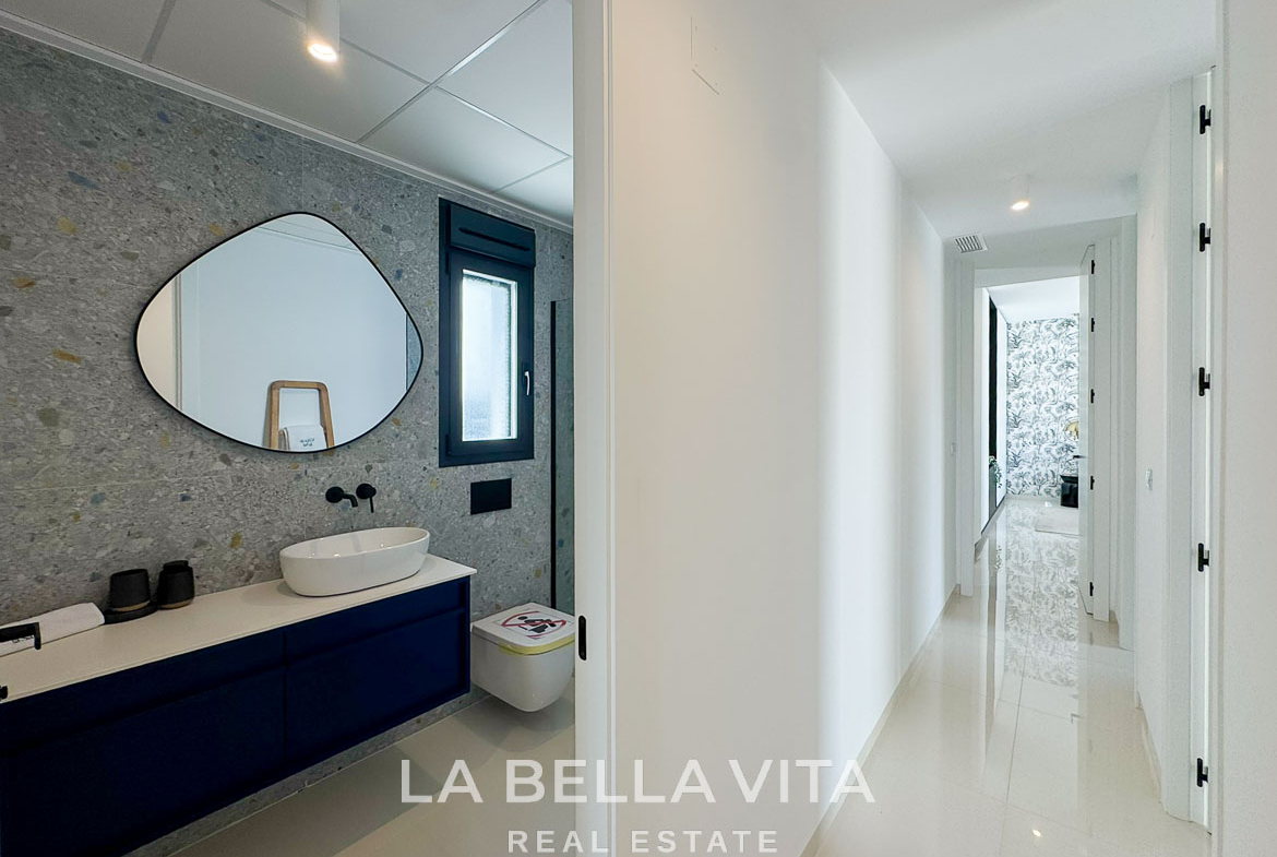 Bright, modern bathroom and sleek hallway in a new 3-bedroom villa with private pool in San Miguel de Salinas