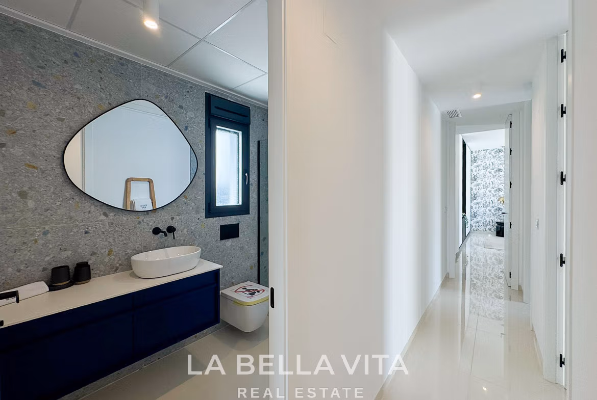 Bright, modern bathroom and sleek hallway in a new 3-bedroom villa with private pool in San Miguel de Salinas