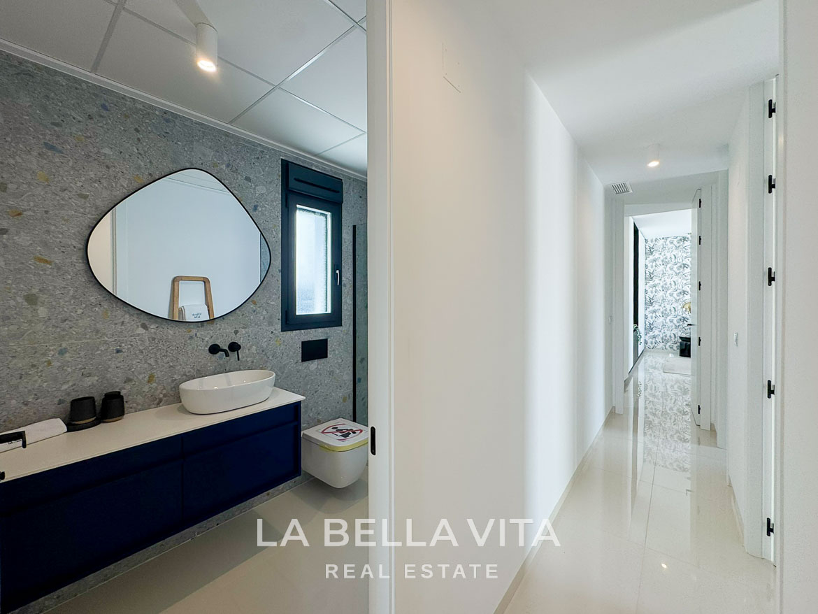 Bright, modern bathroom and sleek hallway in a new 3-bedroom villa with private pool in San Miguel de Salinas