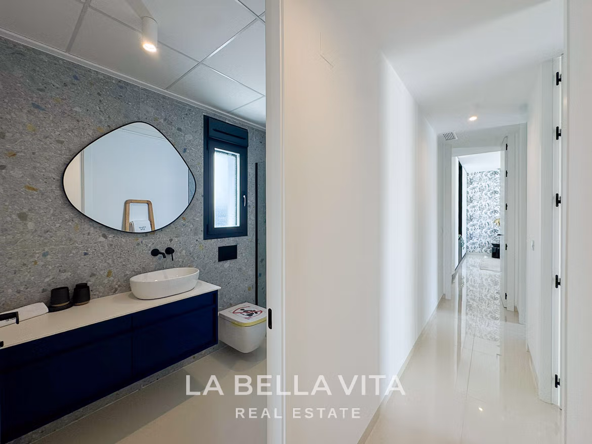 Bright, modern bathroom and sleek hallway in a new 3-bedroom villa with private pool in San Miguel de Salinas