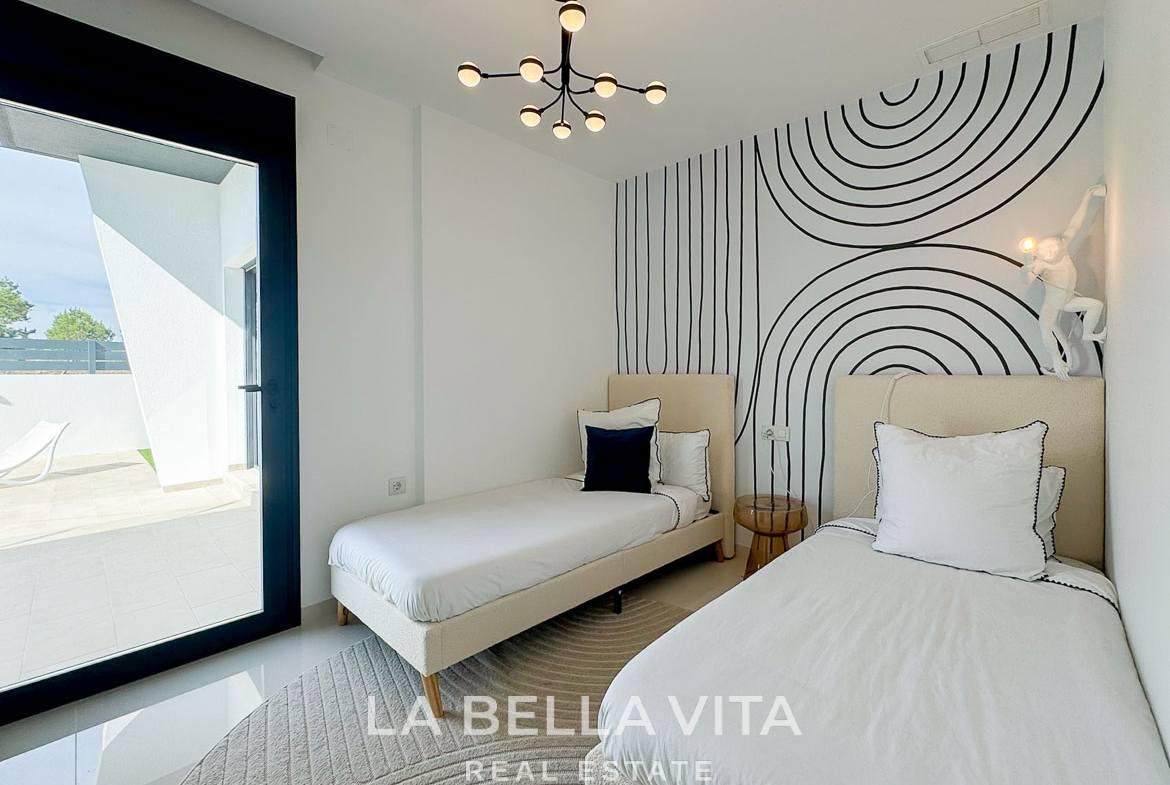 Bright modern twin bedroom with striking geometric wall art and terrace access in a new 3-bedroom villa, San Miguel de Salinas