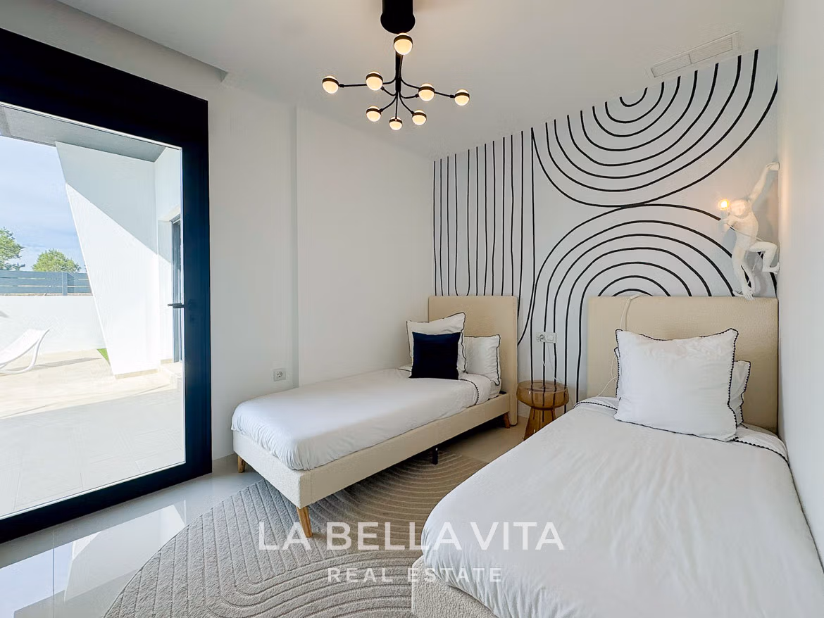 Bright modern twin bedroom with striking geometric wall art and terrace access in a new 3-bedroom villa, San Miguel de Salinas