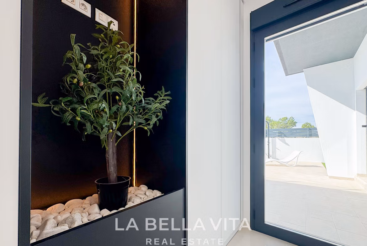 Bright modern interior with sleek planter and sliding glass door opening to sun-drenched terrace in 3-bedroom villa, San Miguel de Salinas