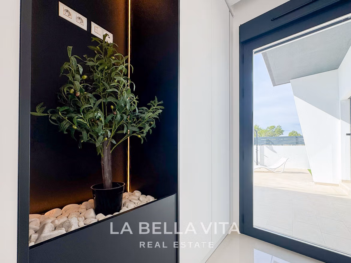 Bright modern interior with sleek planter and sliding glass door opening to sun-drenched terrace in 3-bedroom villa, San Miguel de Salinas