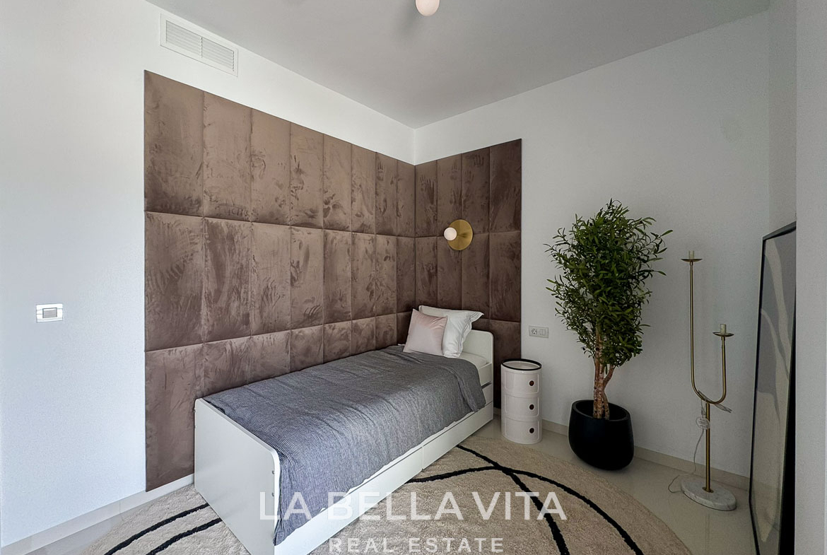 Bright modern bedroom with plush brown upholstered wall, minimalist decor in 3-bedroom villa in San Miguel de Salinas