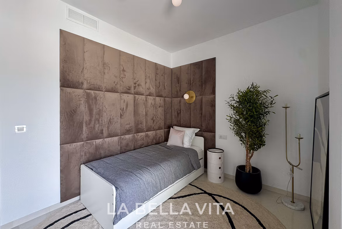 Bright modern bedroom with plush brown upholstered wall, minimalist decor in 3-bedroom villa in San Miguel de Salinas