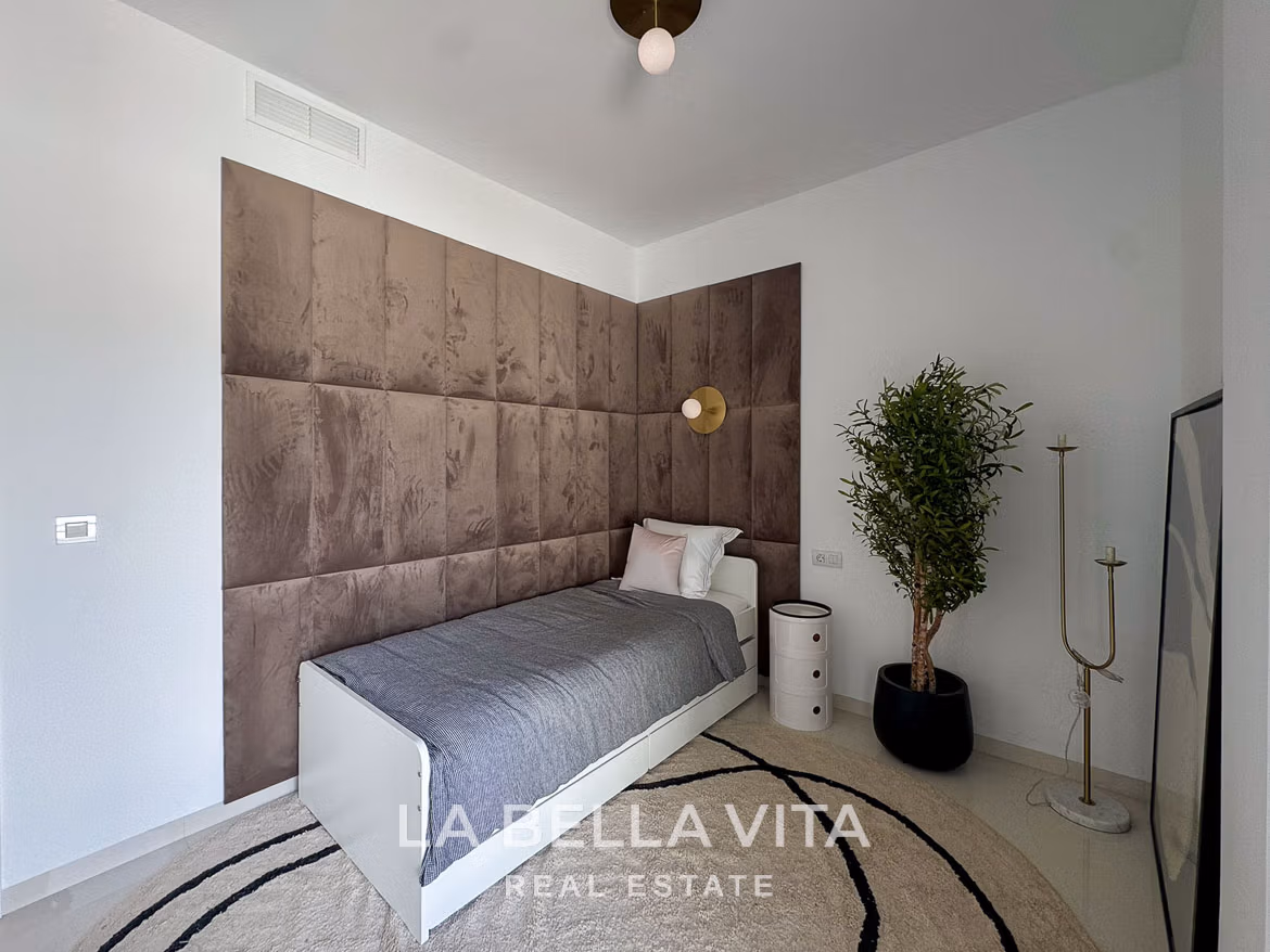 Bright modern bedroom with plush brown upholstered wall, minimalist decor in 3-bedroom villa in San Miguel de Salinas