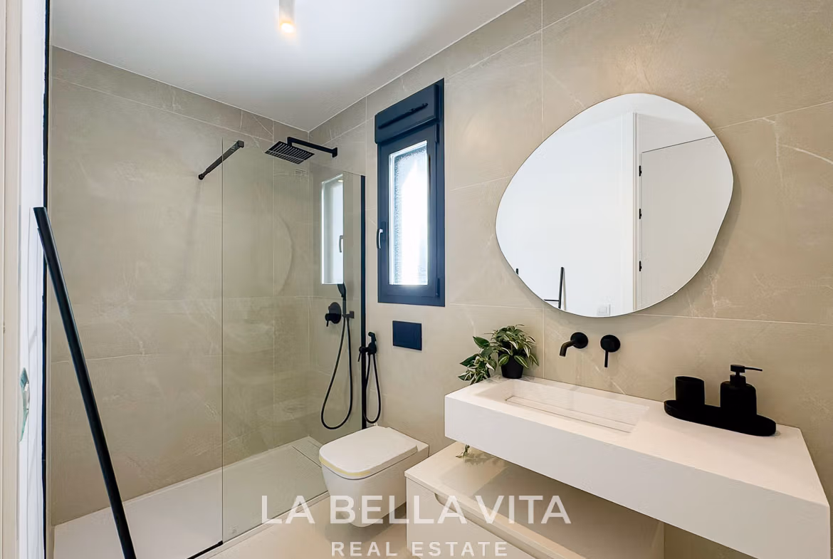 Bright modern bathroom with sleek fixtures and glass shower in luxury 3-bedroom villa, San Miguel de Salinas.