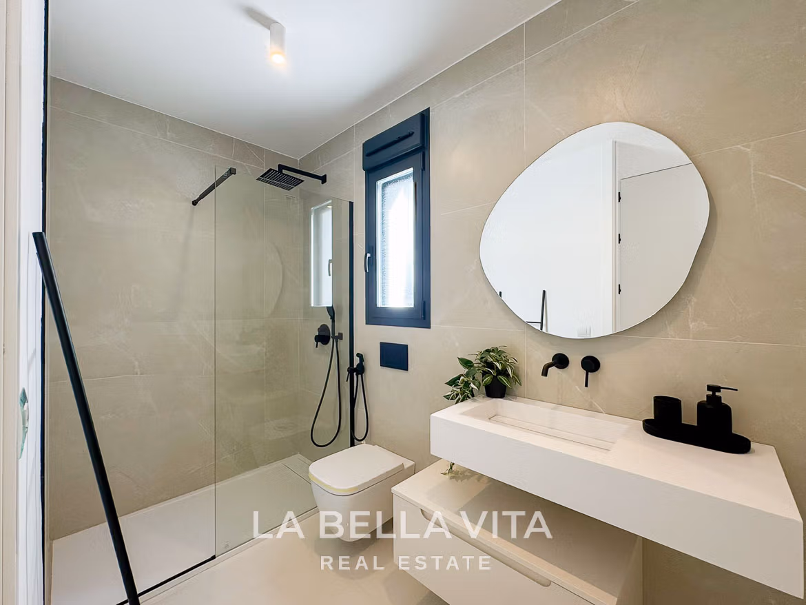 Bright modern bathroom with sleek fixtures and glass shower in luxury 3-bedroom villa, San Miguel de Salinas.